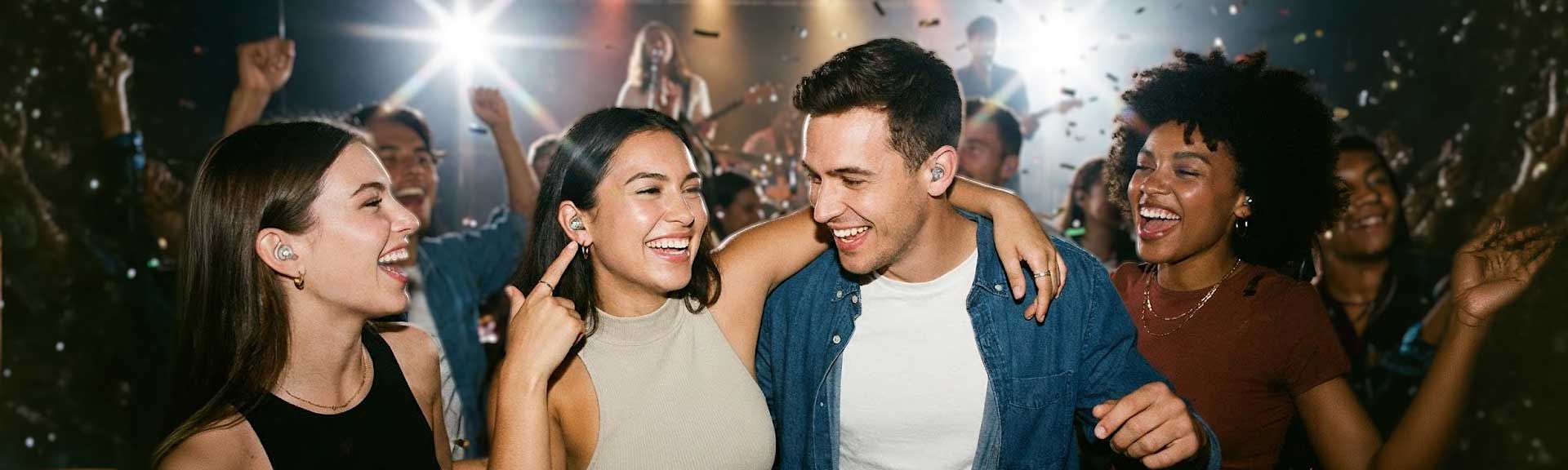 Young people at a concert wearing earplugs